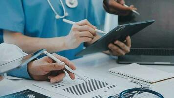 Doctors and nurses in a medical team stacking hands video