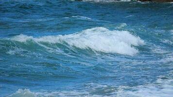 Rolling sea wave and crushing on the beach in slow motion video