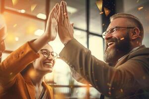 happy people are giving each other a high five in a bright business office with photo