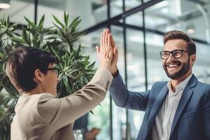 happy people are giving each other a high five in a bright business office with photo