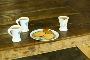 Beautiful tea cups on table with chocolate biscuits naan khatai morning tea morning freshness tea photo