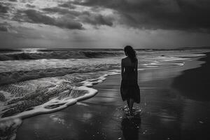 Girl on the beach at sunset. Black and white photo of a girl in a dress on the beach.