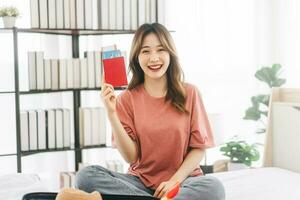 Young adult southeast asian woman showing passport ready for travel trip photo