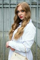 attractive blonde woman with long hairs in a white blouse photo