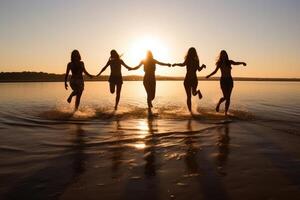 Young group of people jumping into the air at beach. photo