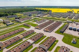 aerial panoramic view over silos and rows of barns, pigsties, chicken coops of huge agro-industrial livestock complex photo