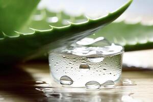 Glass jar of aloe vera juice and fresh aloe vera leaves. photo