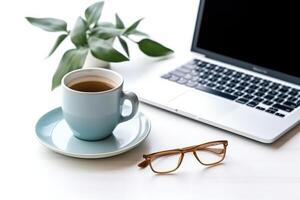 phone, cup of coffee and eucalyptus with a laptop concept photo. photo