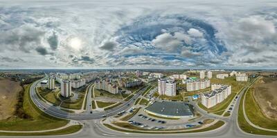 aerial seamless spherical hdri 360 panorama view above road junction with traffic in residential complex with high-rise buildings in town in equirectangular projection. photo