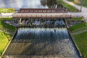 aerial view over dam lock sluice on lake impetuous waterfall photo