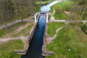 aerial view over dam lock sluice on lake impetuous waterfall photo