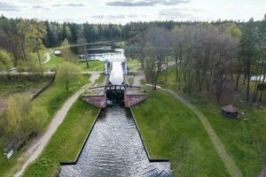 aerial view over dam lock sluice on lake impetuous waterfall photo