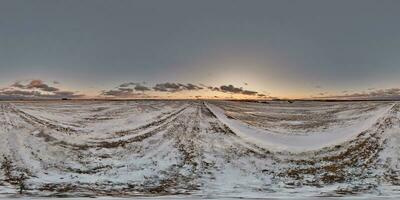 evening 360 hdri panorama on farming field with snow and dark blue sky with in equirectangular spherical seamless projection, use as sky replacement in drone panoramas, game development as sky dome photo