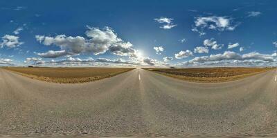 spherical 360 hdri panorama on asphalt road with clouds and sun on blue sky in equirectangular seamless projection, as sky replacement in drone panoramas, game development as sky dome or VR content photo