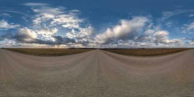 evening 360 hdri panorama on gravel road with clouds on blue sky before sunset in equirectangular spherical seamless projection, use as sky replacement in drone panoramas, game development as sky dome photo