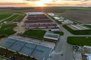 aerial panoramic view over silos and rows of barns, pigsties, chicken coops of huge agro-industrial livestock complex photo