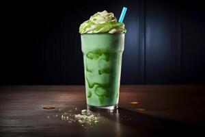 A green milkshake with a blue straw and a cup of green shamrock ice cream. photo