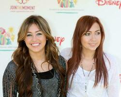 Miley Cyrus and Sister Brandi Cyrus arriving at the A Time For Heroes Celebrity Carnival benefiting the Elizabeth Glaser Pediatrics AIDS Foundation at the Wadsworth Theater Grounds in Westwood , CA on June 7, 2009 photo