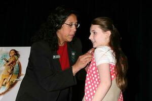 Victoria Garcia Chief Field Services Officer of San Fernado Valley, CA pins Abigail Breslin during her induction into the Girl Scouts of the USA
Zanuck Theater
20th Century Fox Lot
Century City, CA 
March 26, 2008
 2008 Kathy Hutchins Hutchins Photo