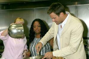 Sherri Shepherd and Cameron Mathison in the Wolfgang Puck Catering kitchen demonstrating and trying the deserts for the Daytime Emmy dinner adjacent to the Kodak Theater piror to Daytime Emmys at the Kodak Theater in Hollywood, CA June 19, 2008 photo