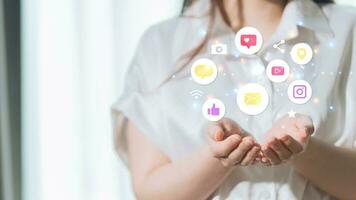 Woman holding social media icons in her hands. Communication and networking concept photo