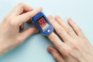 Pulse oximeter measuring oxygen saturation in blood and heart rate photo