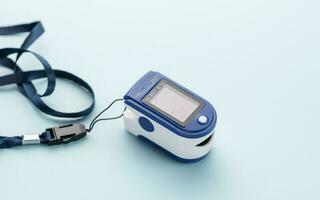 Pulse oximeter on blue background photo