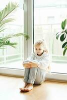 Lonely sad girl near the window. photo