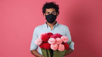 Cropped Image of Young Man Wearing Mask and Holding Dahlia Bouquet on Pastel Red Background. . photo