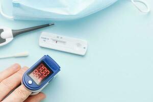 Pulse oximeter measuring oxygen saturation in blood and heart rate photo