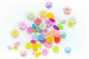 Sweet lollipops and candies on white background photo