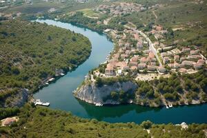 un pequeño europeo pueblo en un montaña con un río, ver desde el cima. generativo ai foto