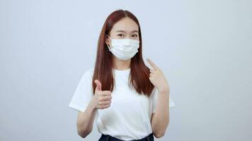 women wearing white shirts and jeans are recommended to wear a mask as a sign of excellence. video