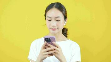 Nahansicht Video von asiatisch Frau tragen Kopfhörer während spielen Smartphone online.