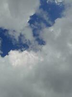 hermosas nubes blancas sobre fondo de cielo azul profundo. grandes nubes esponjosas suaves y brillantes cubren todo el cielo azul. foto