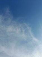 nubes blancas en el cielo azul. hermoso fondo azul brillante. nubosidad ligera, buen tiempo. nubes rizadas en un día soleado. foto