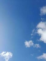 Beautiful white clouds on deep blue sky background. Large bright soft fluffy clouds are cover the entire blue sky. photo