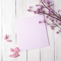 Blank Paper Card Mockup and Blossom Branch Flat Lay on White Wooden Table Top, . photo