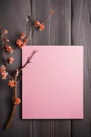 Top View of Blank Pink Paper Card Mockup and Cherry Blossom Branch on Dark Wooden Texture Table, . photo