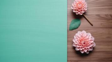 Top View of Teal Green Blank Paper Card with Beautiful Dahlia Flowers Mockup on Wooden Table, . photo