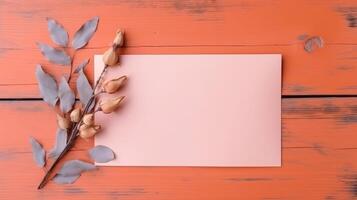 Pink Blank Paper Card Mockup, Dried Leaves and Seed Pods Branch on Orange Wooden Texture Table Top. . photo