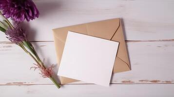 Blank White Paper Card, Kraft Envelope Mockup and Floral Decorations on Wooden Texture Table Top. . photo