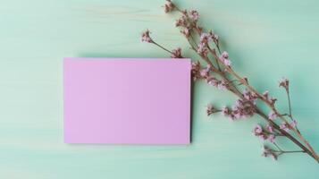 Blank Paper Card Mockup and Flower Branch Flat Lay on Pastel Turquoise Texture Background. . photo