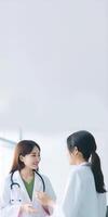 Cropped Image of Asian Female Doctors Talking Each Other on White Background, Vertical Banner Design. . photo