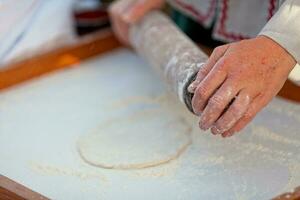 Medieval baker making a fouace photo