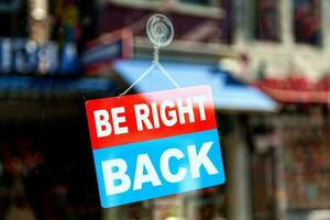 Be right back sign in a store window photo