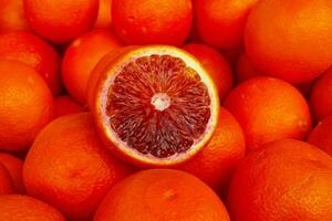 Stack of Blood oranges on a market stall photo
