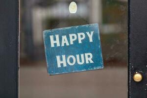 Happy Hour sign in a window photo