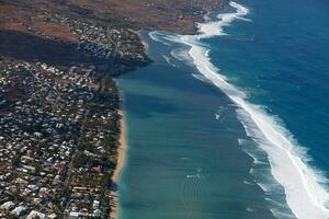 Aerial view of La Saline-Les-Bains on the coast of Reunion Island with the waves crushing on the reef. photo