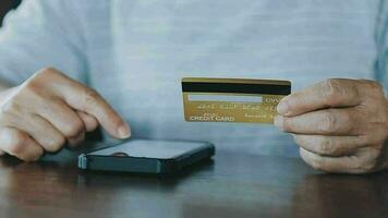 Hands holding credit card and using laptop. Online shopping video